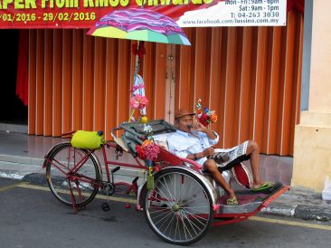 Rickshaw driver resting